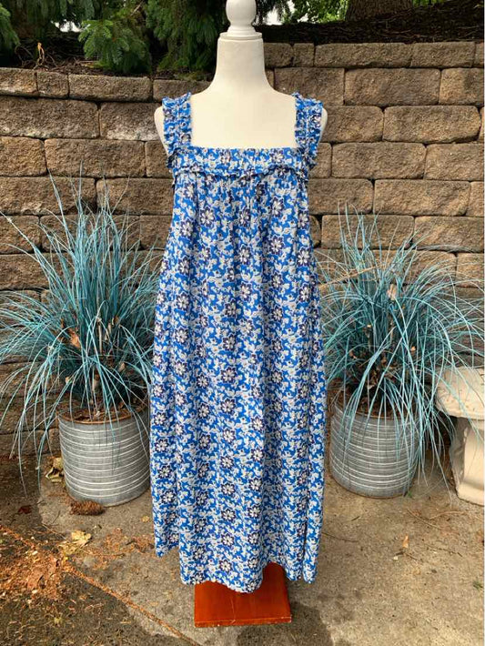 Blue floral sleeveless midi dress with square neckline and gathered bodice on mannequin.