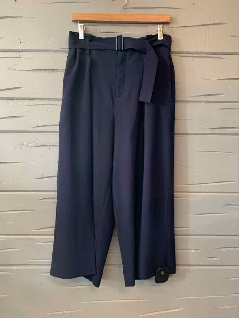 Navy Vince wide-leg trousers with a high waist, belt loops, and a matching fabric tie belt.
