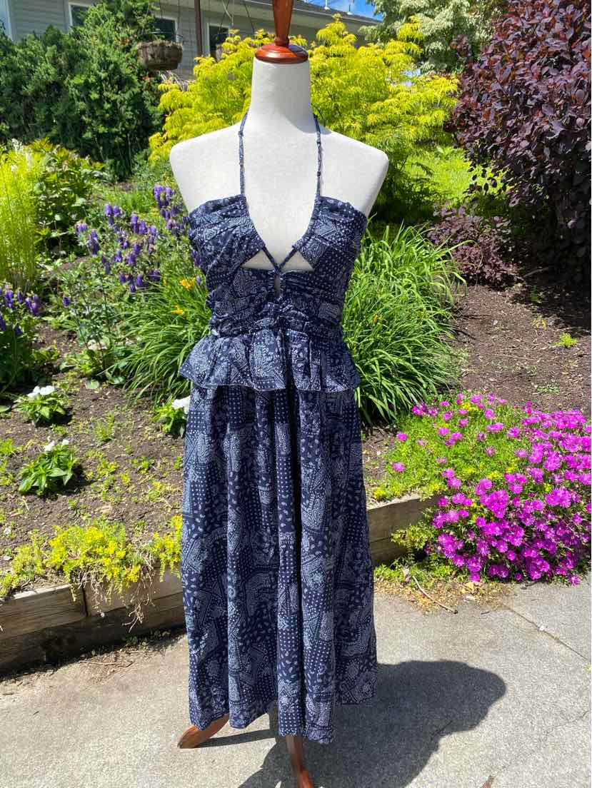 Navy blue sleeveless dress with paisley pattern, deep V-neck, fitted waist, and midi-length skirt.
