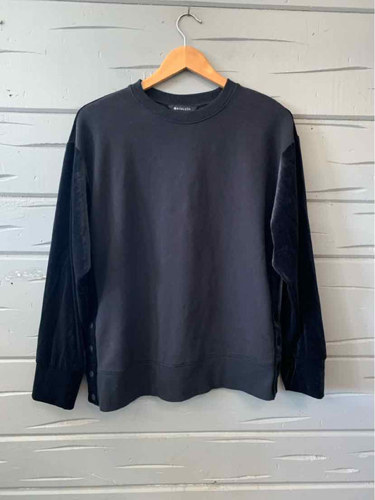 Black long-sleeve crewneck sweatshirt with relaxed fit, ribbed cuffs, and soft fabric.