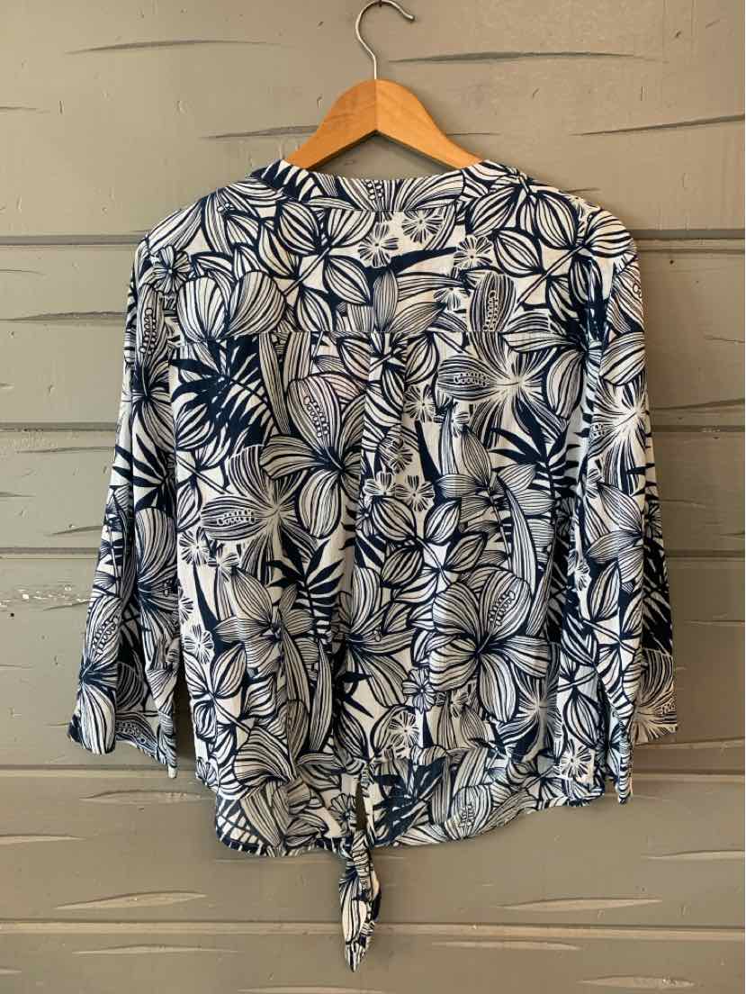 White button-up blouse with navy and gray tropical leaf print, long sleeves, front tie hem.