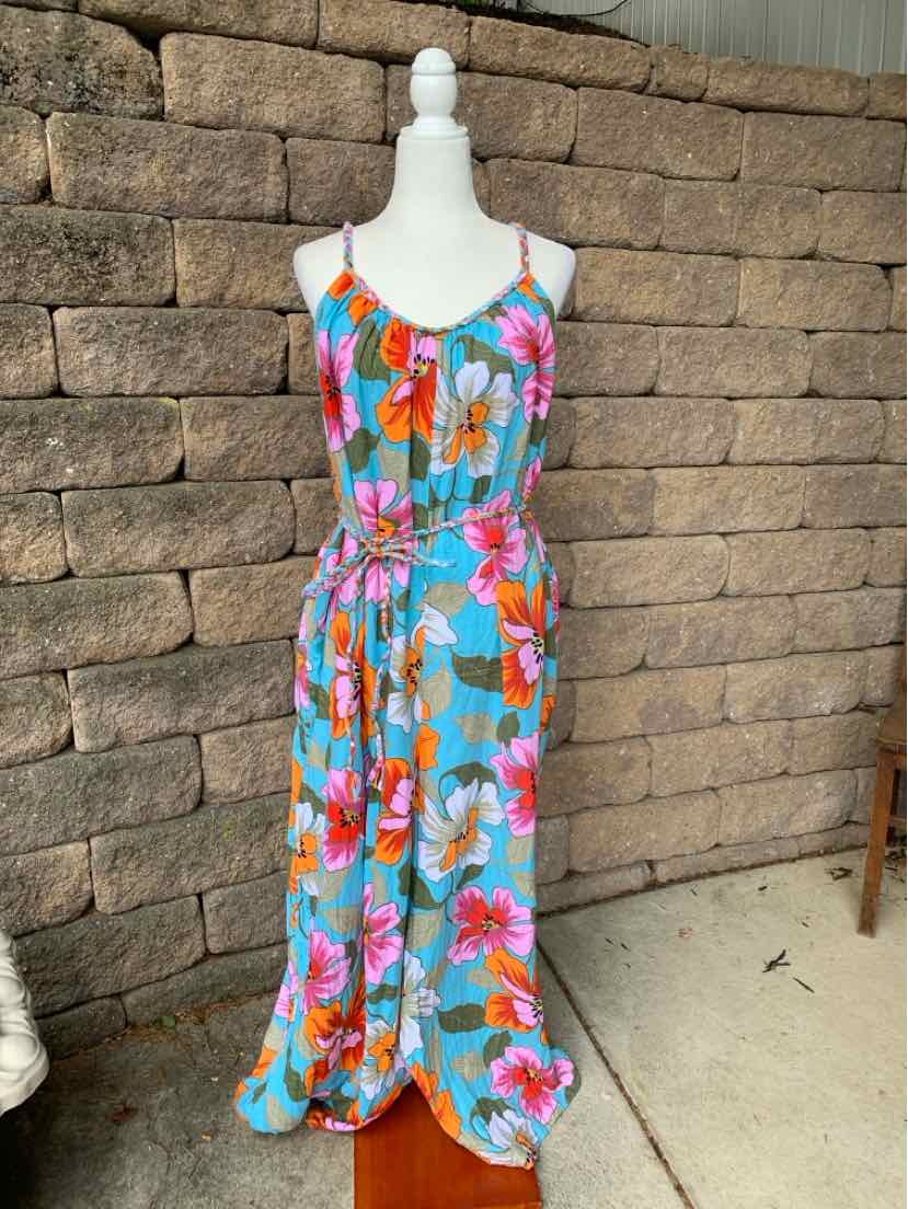 Sleeveless tropical print maxi dress with adjustable spaghetti straps and cinched waist in bright blue, orange, and pink.