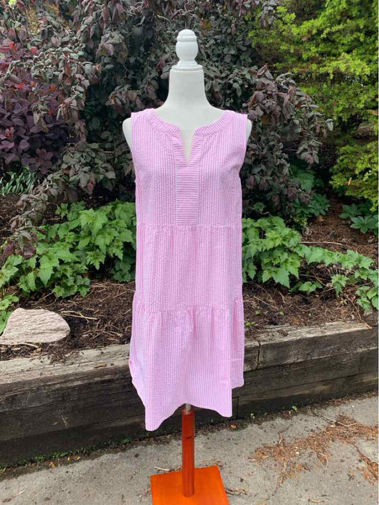 Sleeveless pink knee-length dress with tiered skirt and subtle vertical stripes on mannequin.
