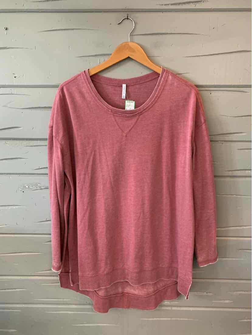 Maroon long-sleeve V-neck knit top with relaxed fit on wooden hanger.