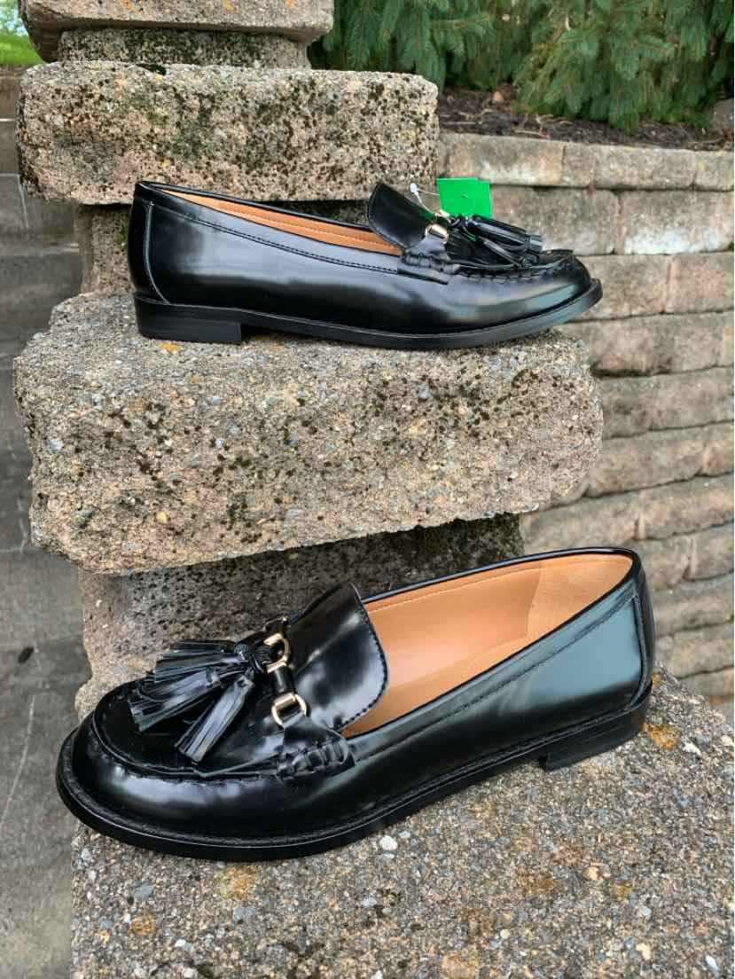Black patent leather loafers with tassels, low heel, and rounded toe, size 8.