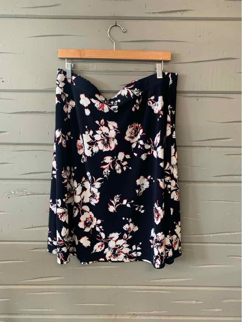 Navy blue skirt with white and pink floral print, flowy fabric, knee-length.