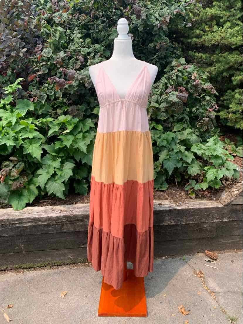 Sleeveless maxi dress with color block tiers in pink, mustard yellow, rust, and mauve.