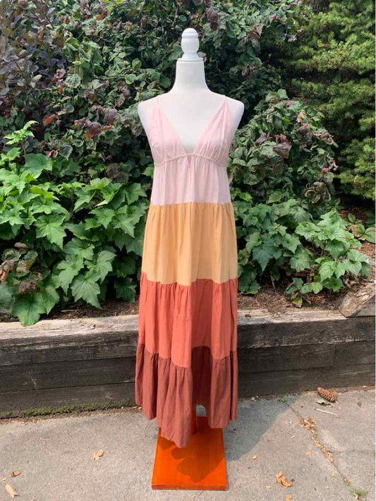 Sleeveless maxi dress with color block tiers in pink, mustard yellow, rust, and mauve.