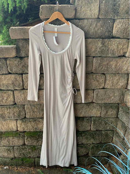 Mauve long-sleeve dress with scoop neckline and side ruching detail on lightweight fabric.