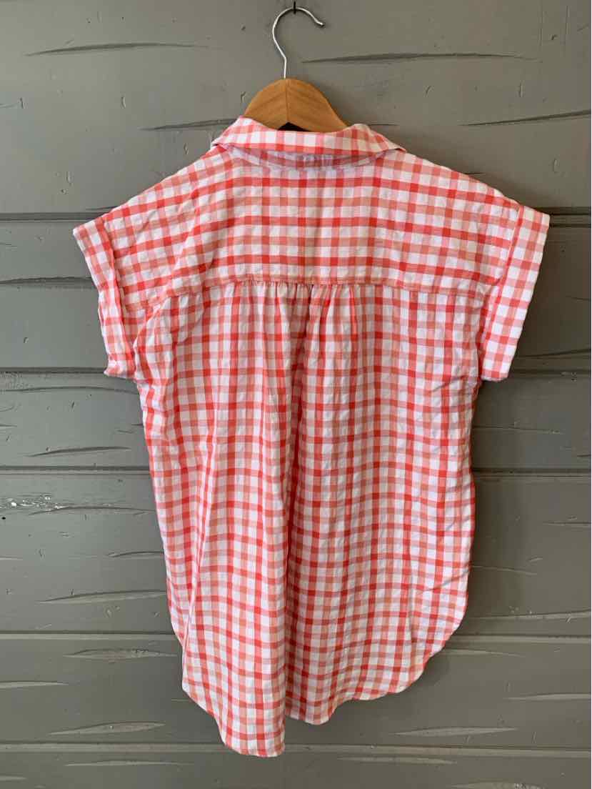 Red and white gingham short-sleeve blouse with gathered back yoke on wooden hanger.