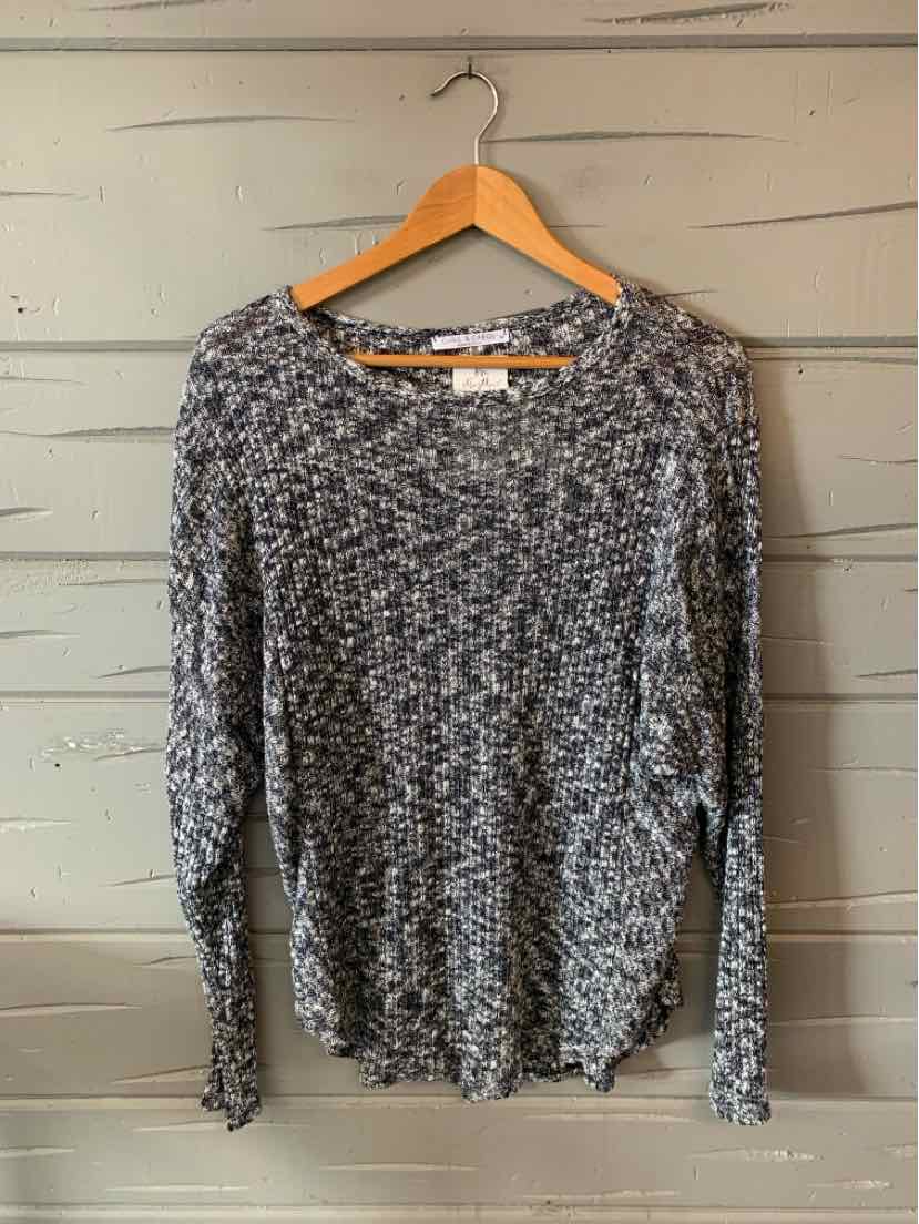 Long-sleeve knit sweater in black and white marled pattern with crew neckline and relaxed fit.