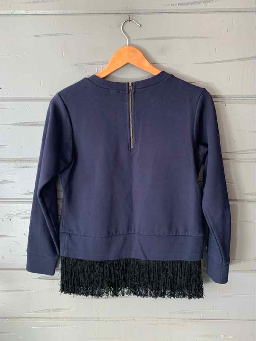 Navy long-sleeve top with a short back zipper and black fringe trim along the hem.