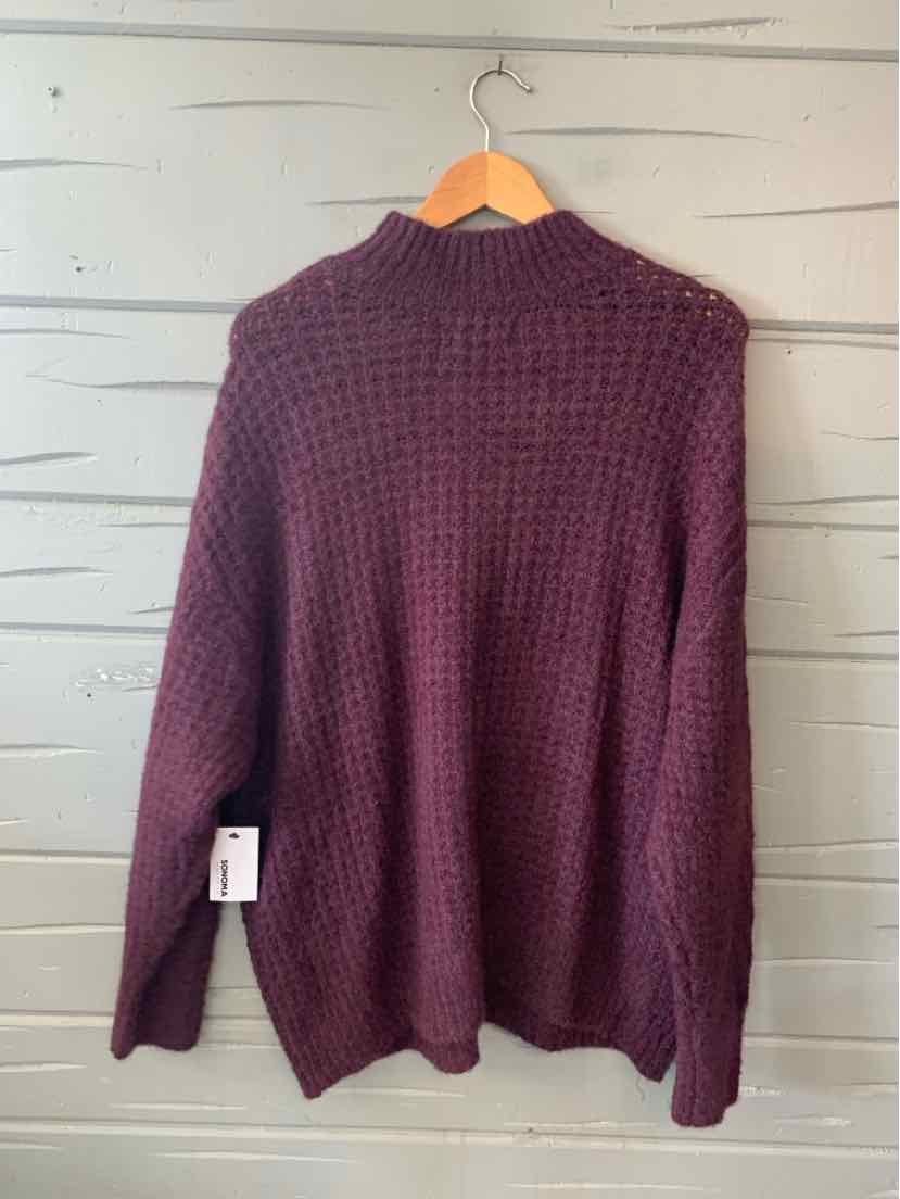 Burgundy waffle-knit sweater with long sleeves and high neckline in size XXL hanging on wooden hanger.