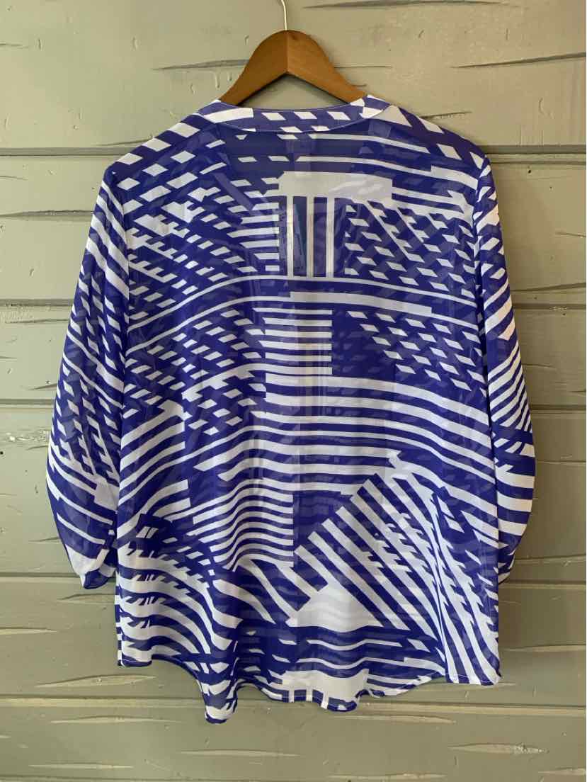 Blue and white geometric patterned long-sleeve blouse in large size on wooden hanger.