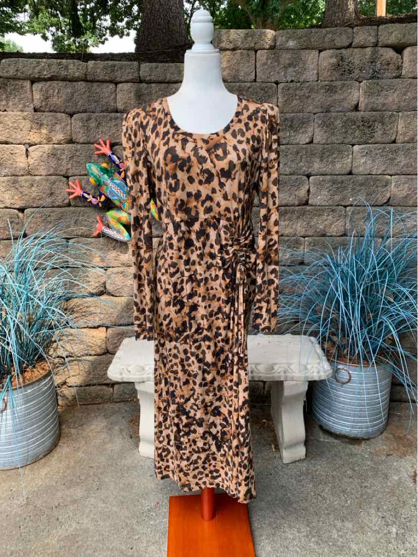 Medium-length leopard print dress with long sleeves and a scoop neckline on a mannequin.