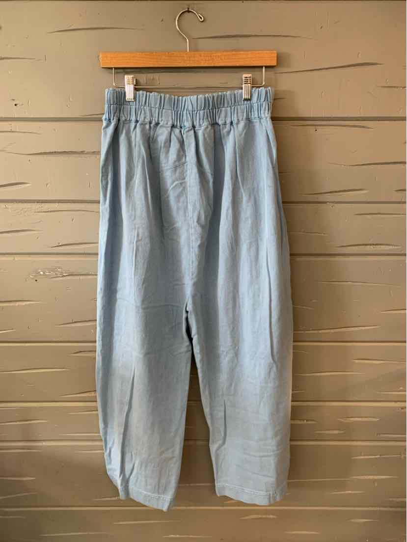 Light blue high-waisted wide-leg pants with elastic waistband and relaxed fit.