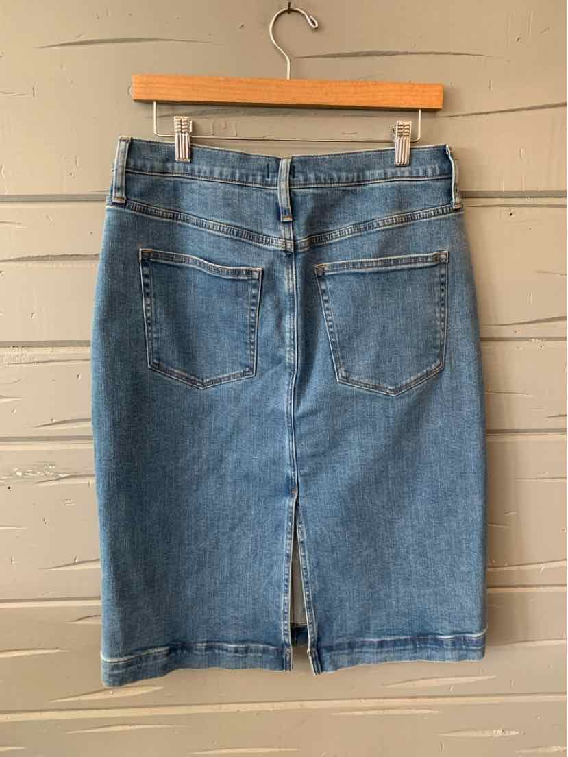 Blue denim pencil skirt with back pockets and a center back slit, size 10, hanging on wooden hanger.
