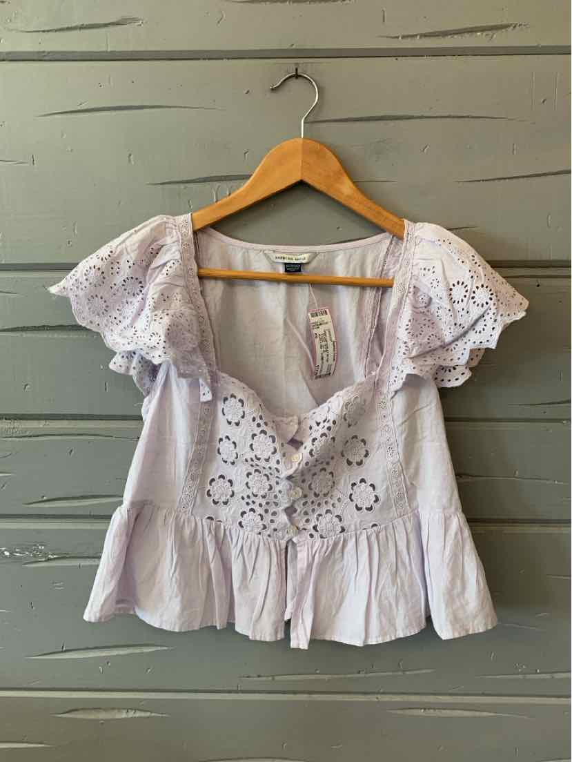Lavender eyelet lace blouse with puff sleeves and peplum hem in size XS.