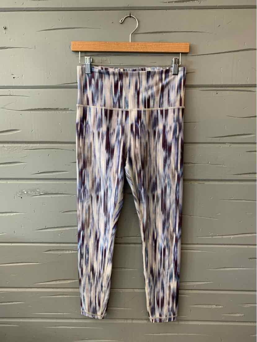 High-waisted athletic leggings with blue and white vertical stripe pattern and tapered ankles.
