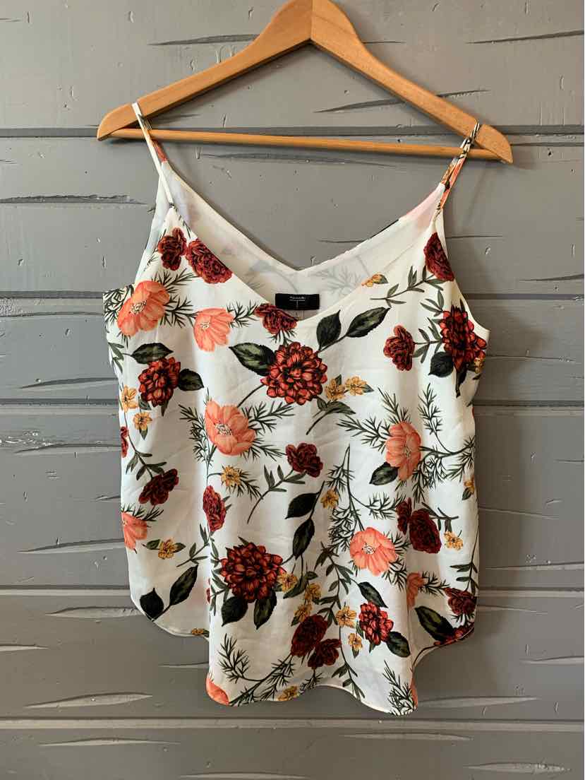 White sleeveless floral print camisole with red, orange, and black flowers and thin adjustable straps.