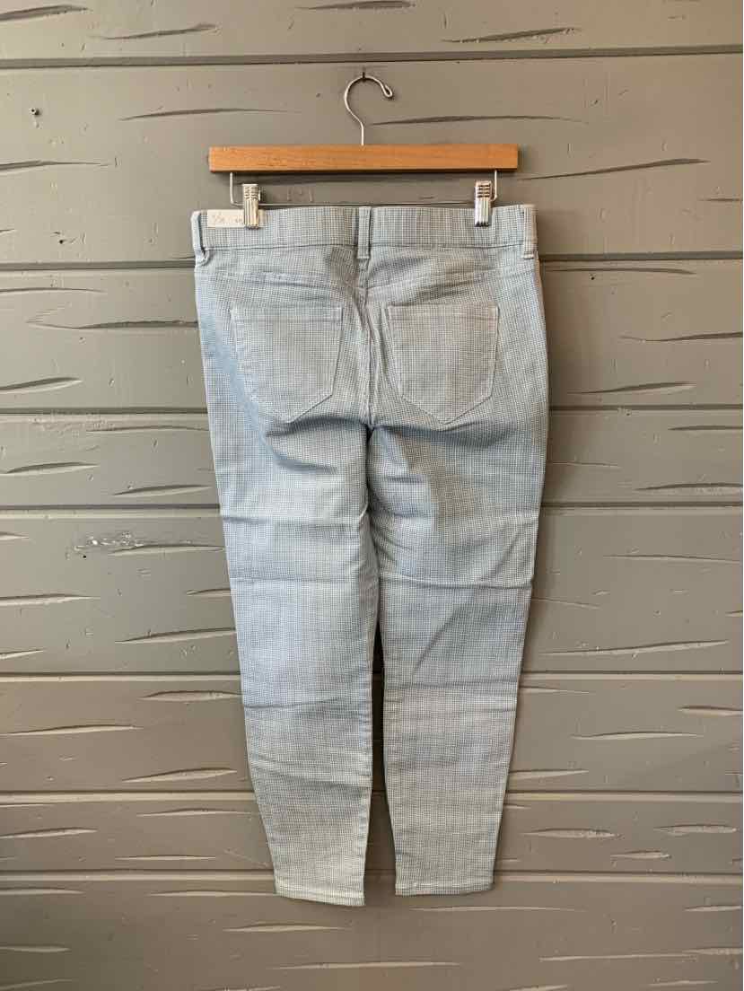 Light blue slim-fit jeans with subtle vertical fading, back pockets, and tapered legs.