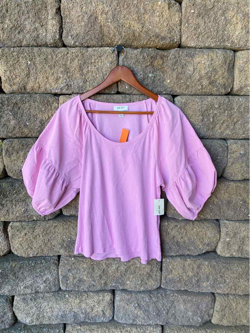 Light purple blouse with puffed three-quarter sleeves and scoop neckline on wooden hanger.