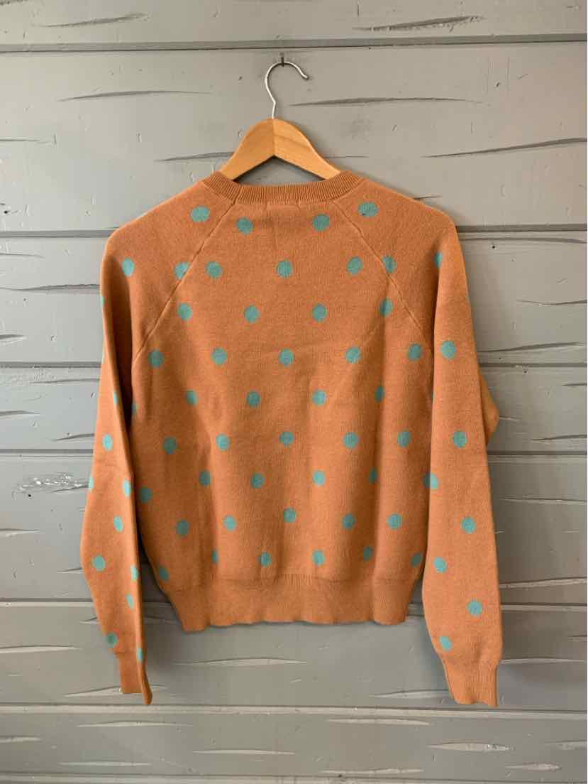 Light brown knit cardigan with blue polka dots, long sleeves, and ribbed cuffs and hem.