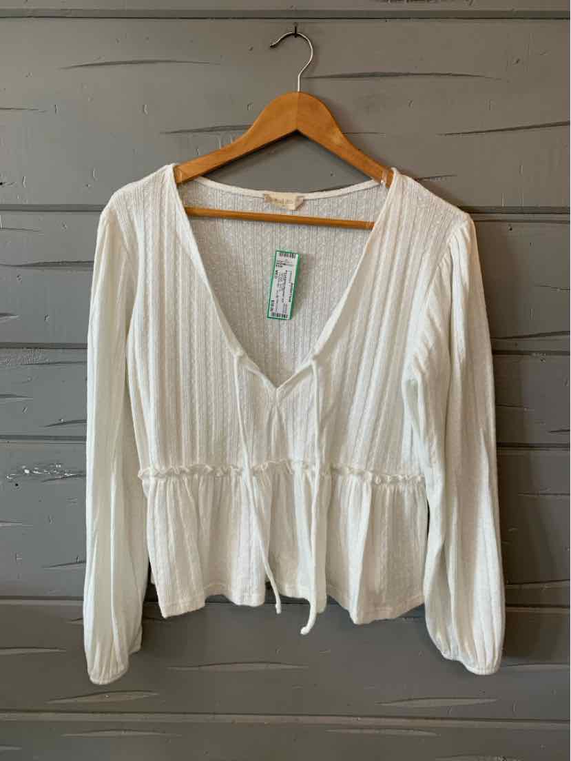 White long-sleeve V-neck blouse with gathered waist and peplum hem on wooden hanger.