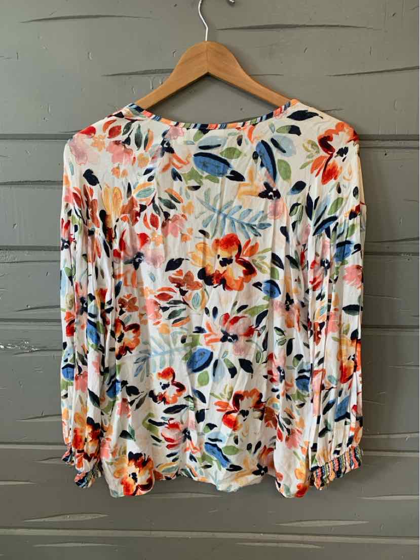 Long-sleeve blouse with vibrant orange and red floral pattern on white background, lightweight fabric.