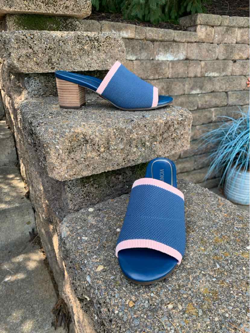 Blue open-toe slide sandals with pink trim, textured fabric upper, and low stacked heel.