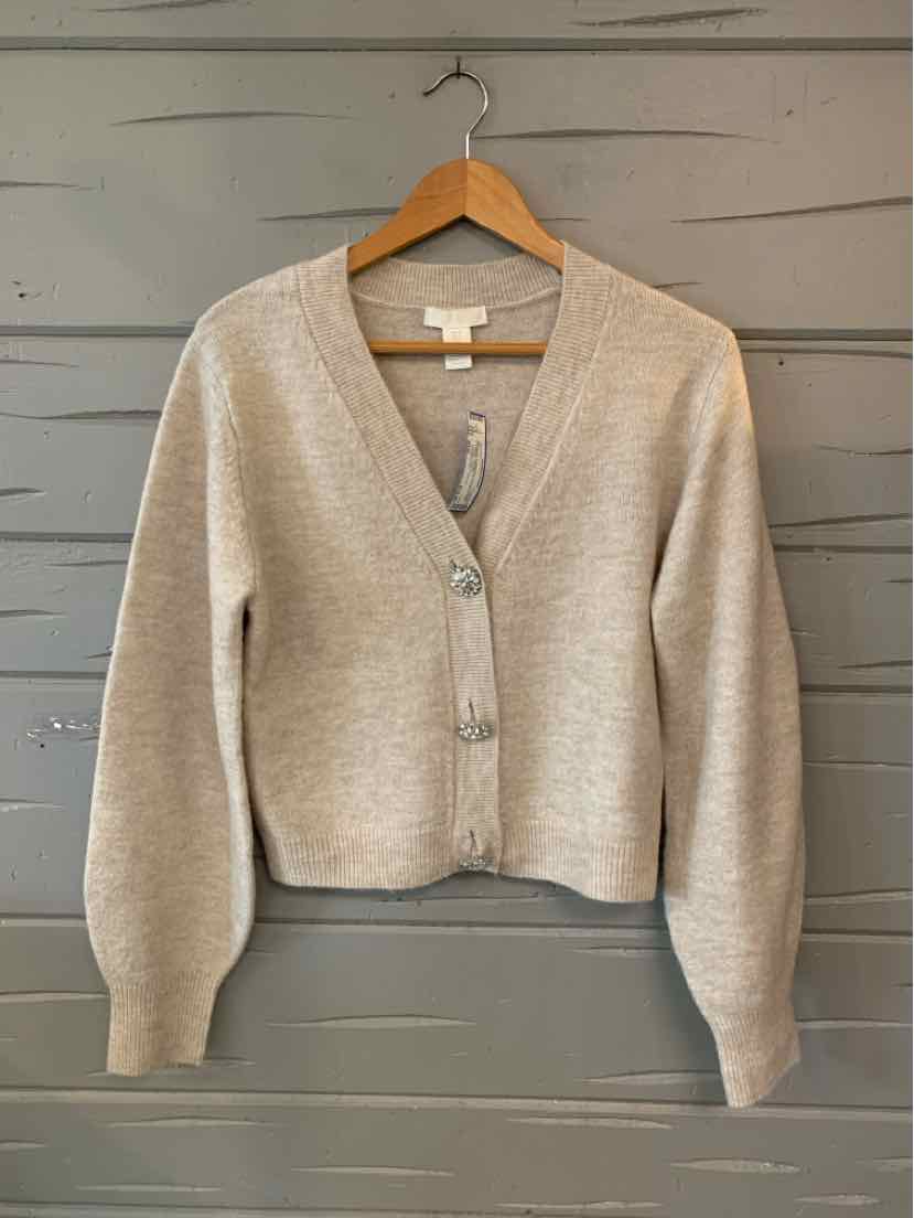 Women’s oatmeal knit cardigan with a V-neck, button front, long sleeves, and ribbed trim.