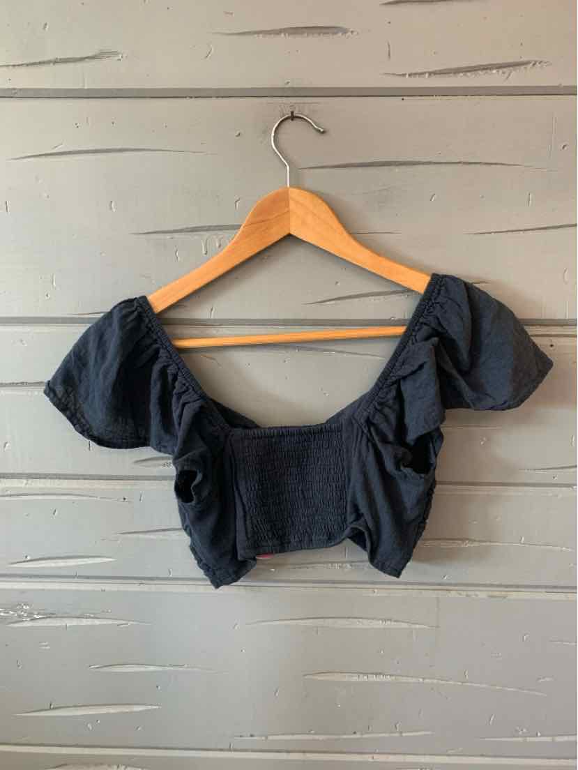 Dark gray cropped blouse with puffed short sleeves and square neckline on wooden hanger.