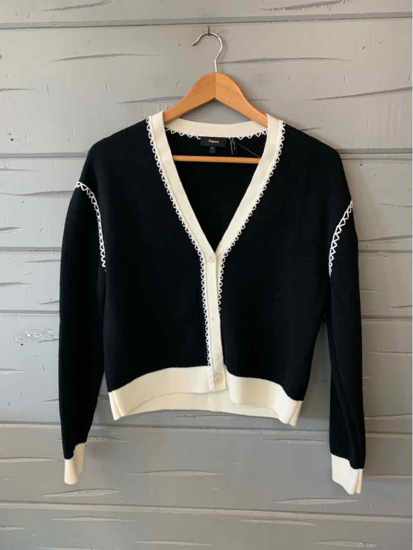 Black knit cardigan with white trim along V-neck, button placket, cuffs, and hem, size small.