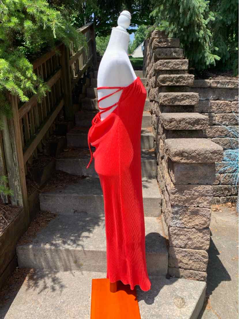 Red sleeveless dress with side cutouts and lace-up detail on fitted bodice.