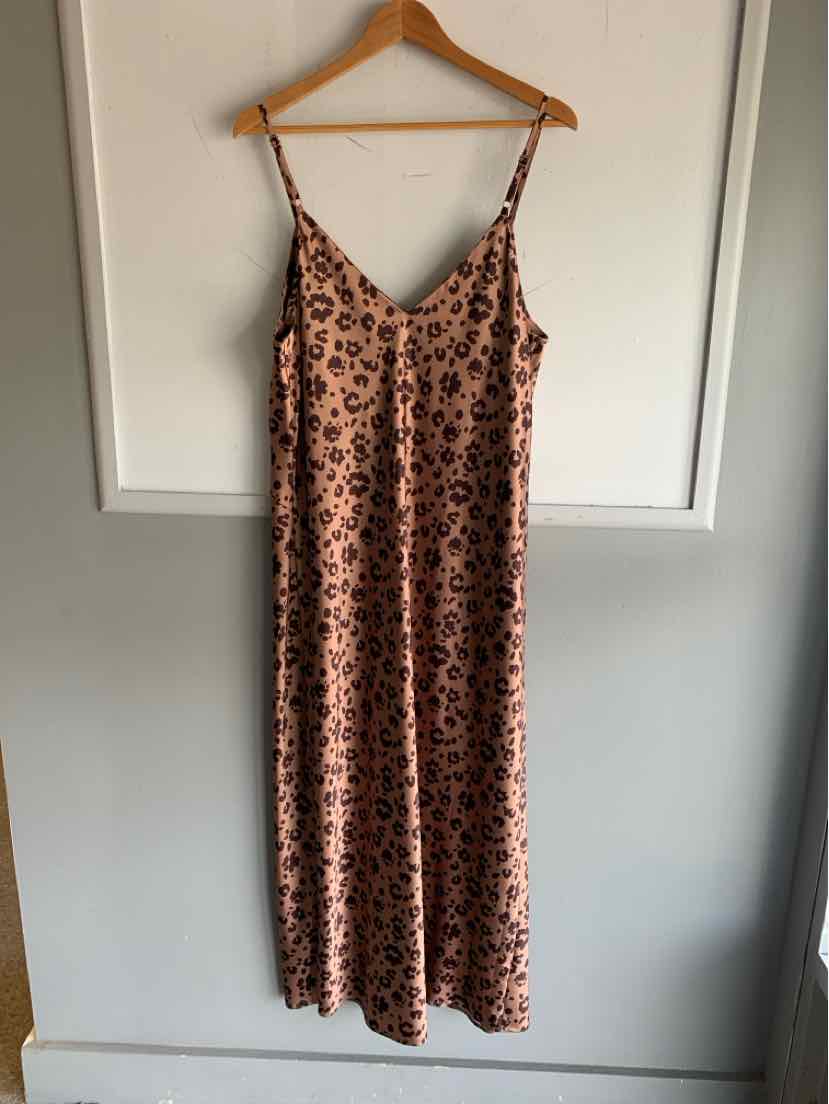 Beige sleeveless maxi dress with thin straps and cheetah print pattern.