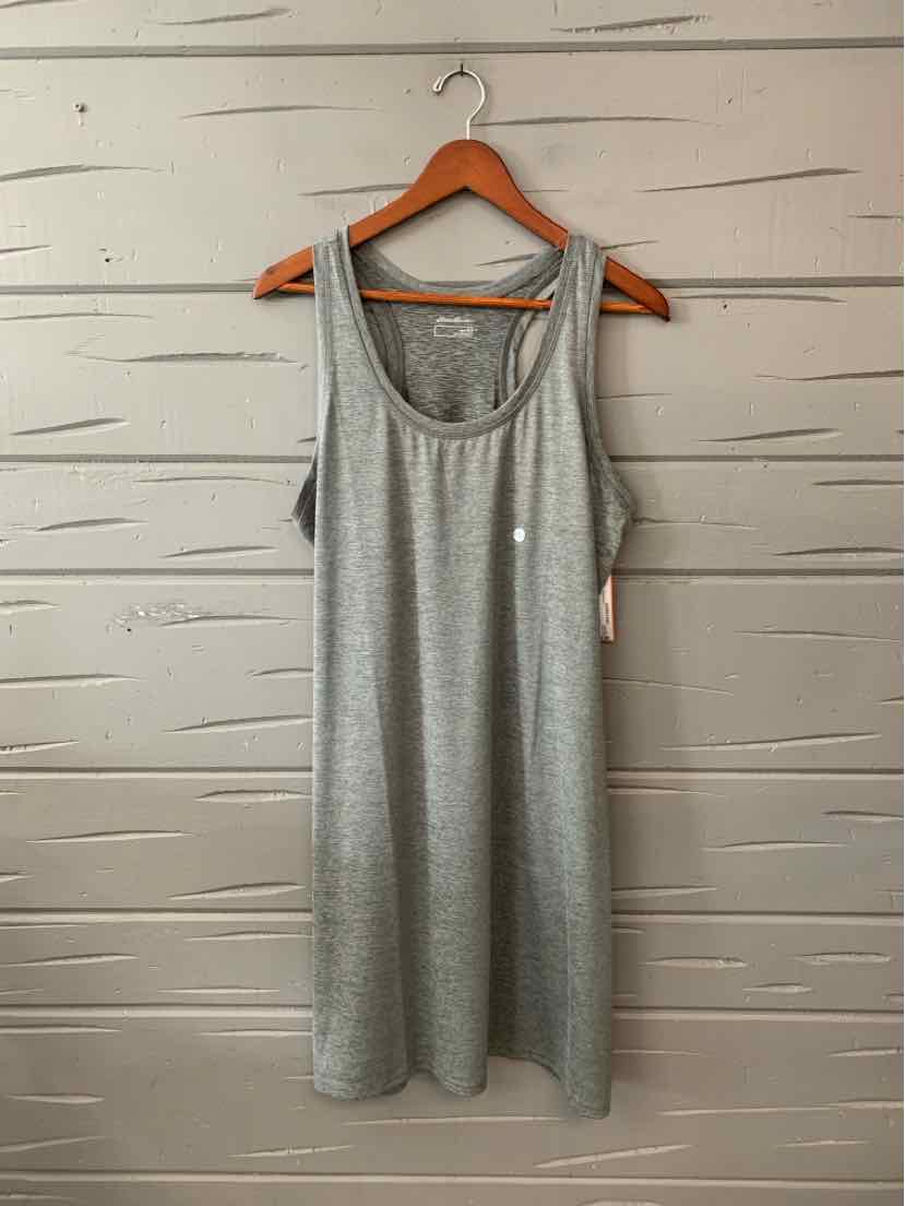 Light gray sleeveless scoop neck dress with relaxed fit hanging on wooden hanger against light wall.