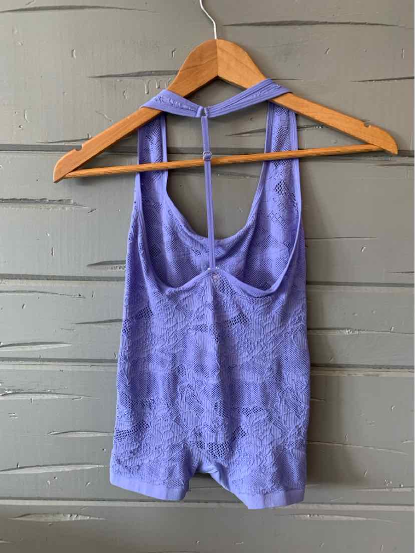Lavender sleeveless lyrebird-print tank top with racerback hanging on wooden hanger.