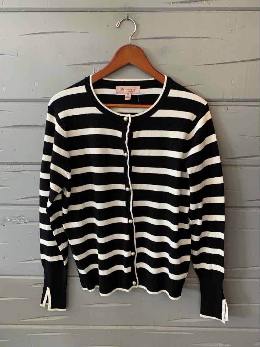 Black and cream striped knit cardigan with front buttons, ribbed cuffs, and a rounded neckline, on a hanger.