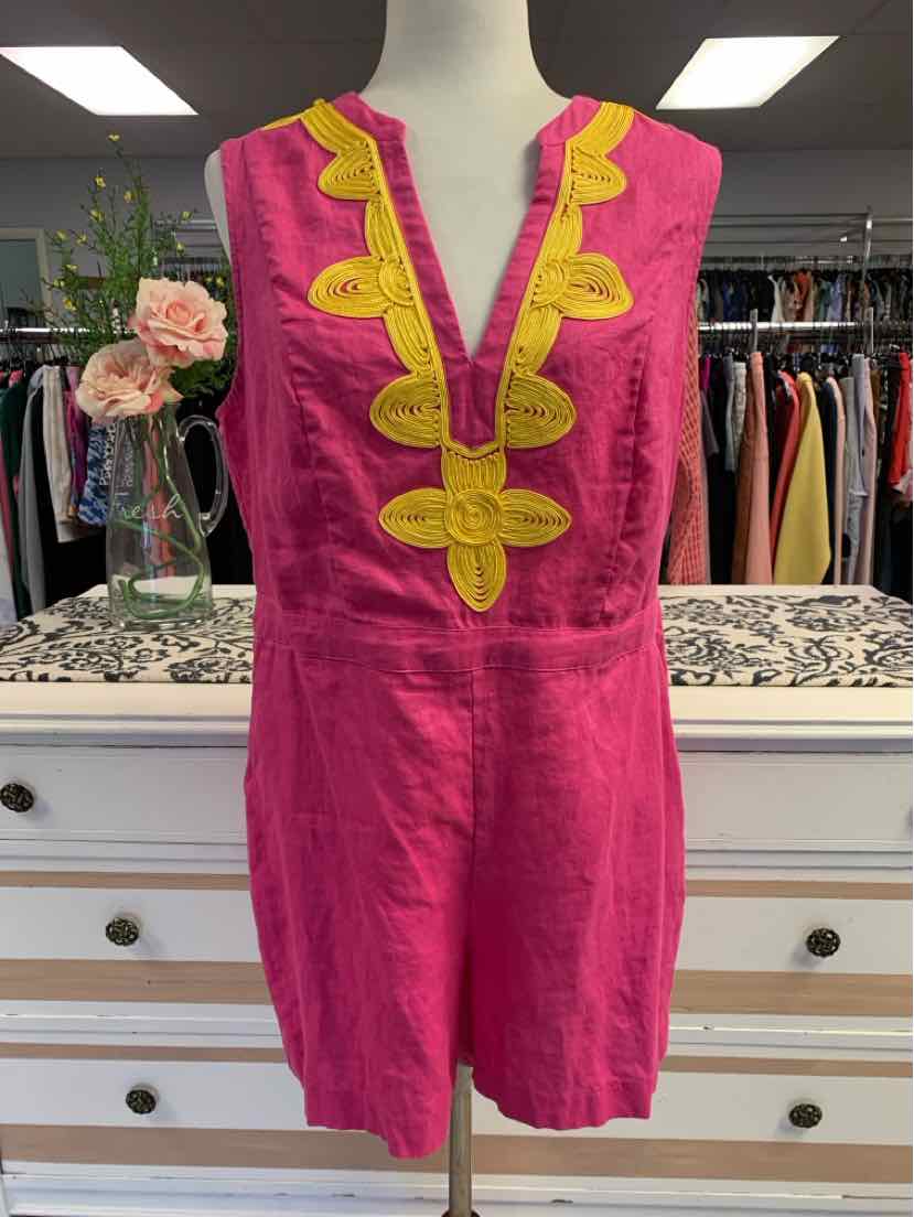 Sleeveless pink tunic with yellow embroidered V-neckline detail on a mannequin.
