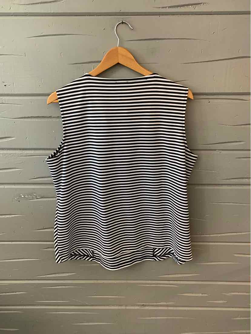 Black and white sleeveless striped blouse with round neckline on wooden hanger.