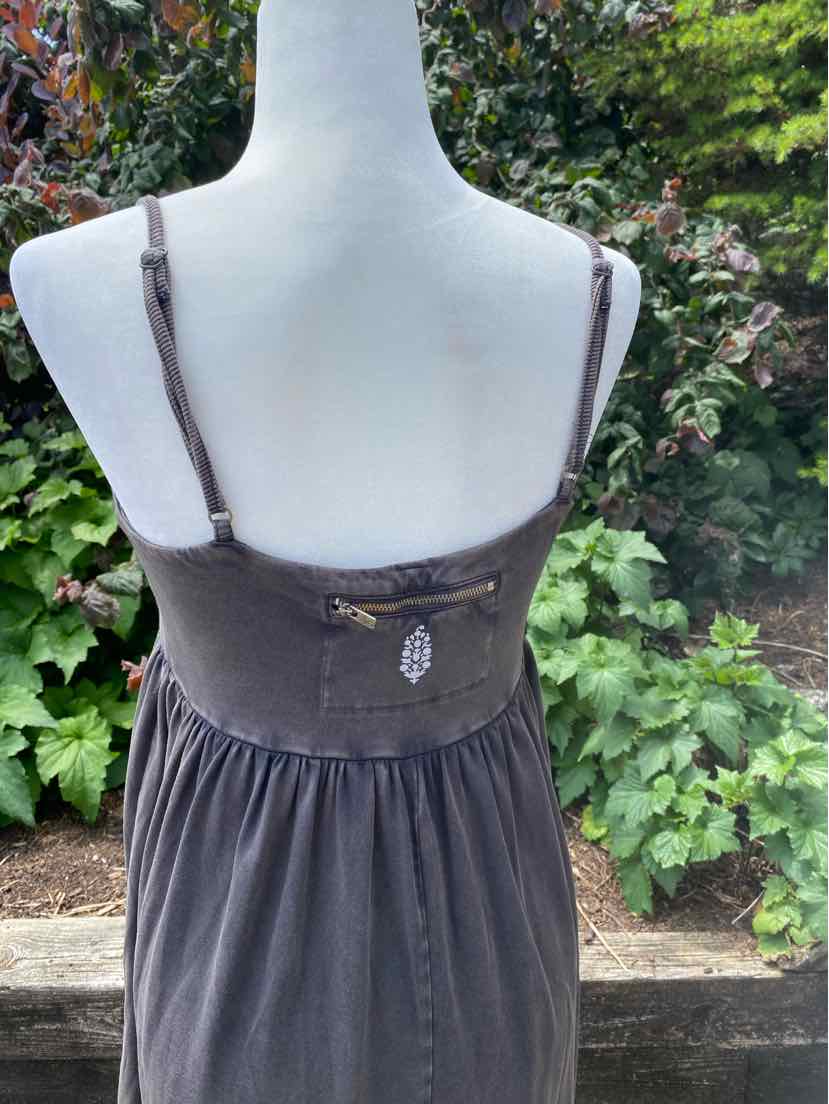 Sleeveless dark gray dress with thin straps and gathered waist, lightweight fabric.