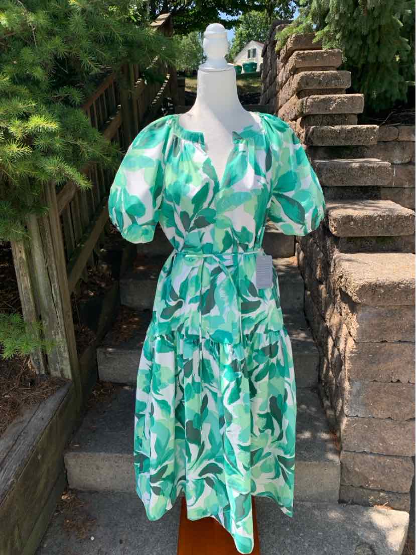 Green and white leaf print midi dress with puff sleeves and V-neckline.
