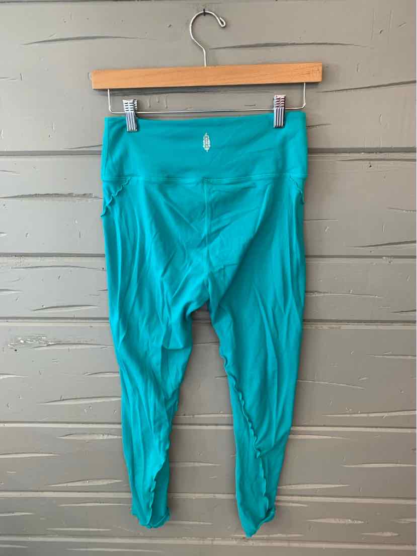 Teal high-waisted cropped leggings with a small white logo on the back waistband.