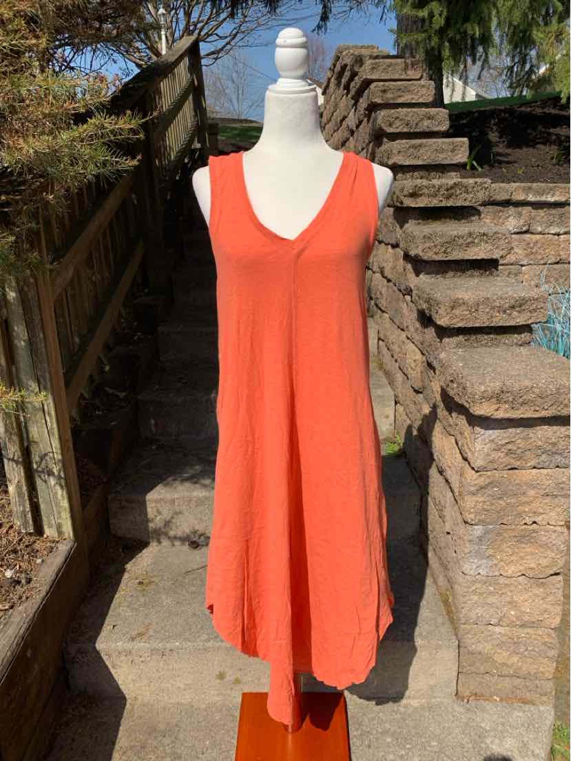 Orange sleeveless V-neck midi dress with relaxed fit on mannequin.