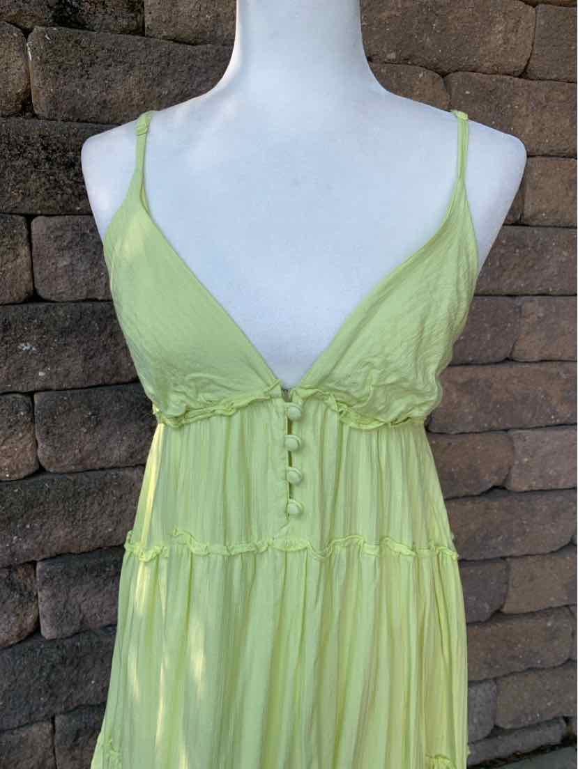 Light green sleeveless dress with spaghetti straps, button-down front, and tiered skirt detailing.