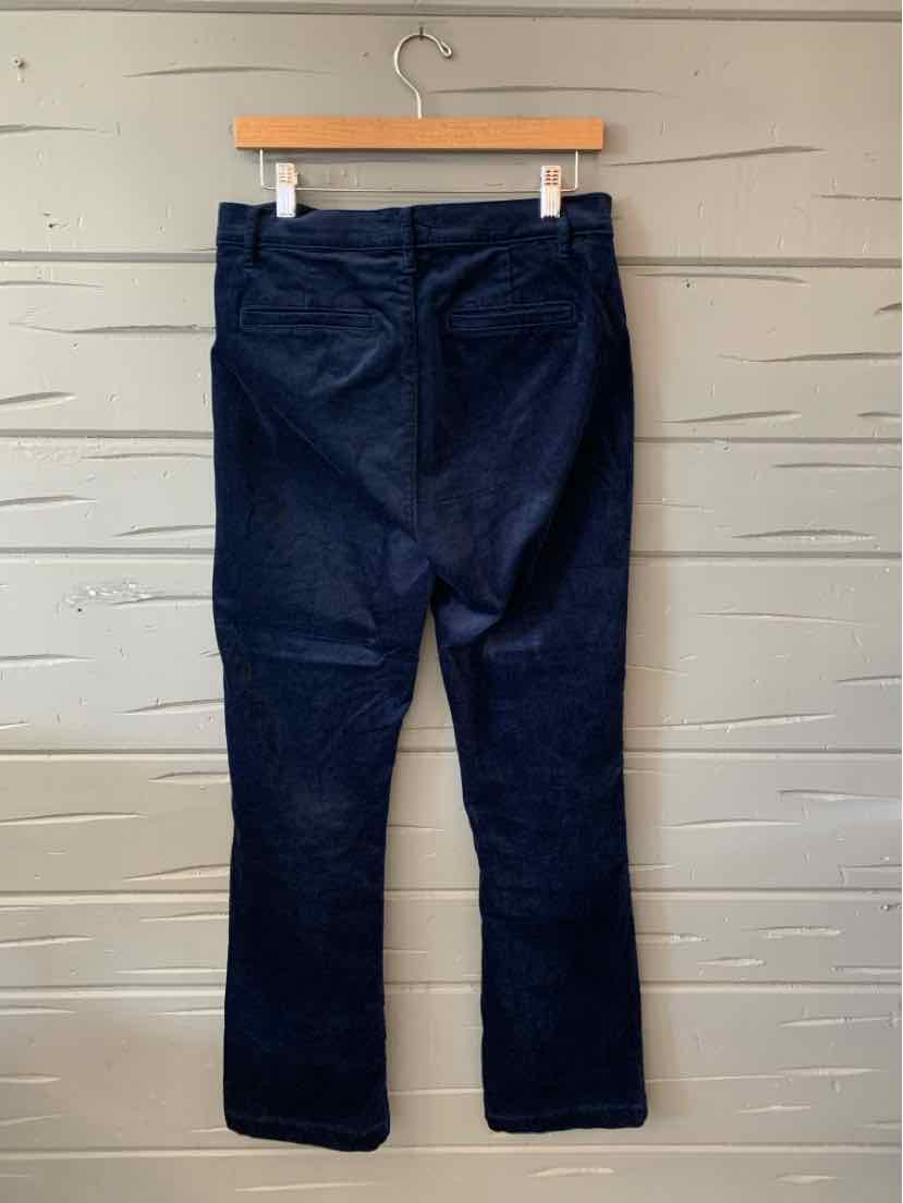 Dark navy straight-leg pants with a mid-rise waist and back pockets hanging on a wooden hanger.