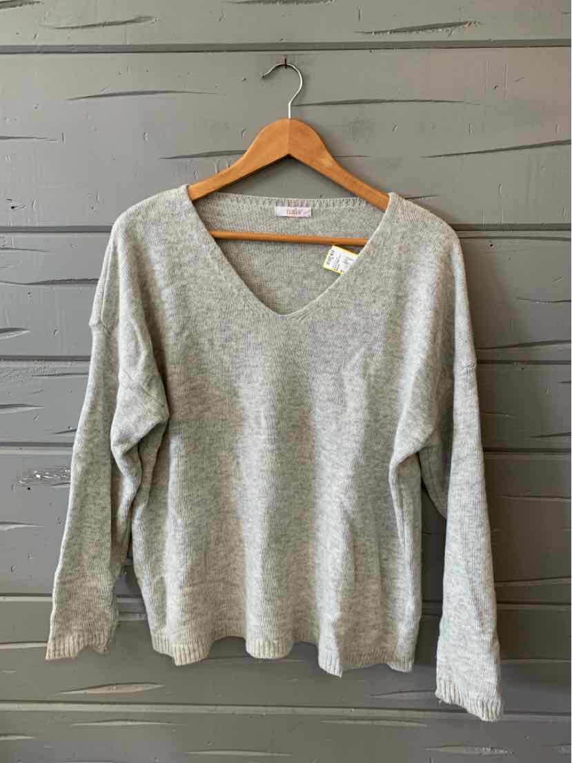 Light gray long-sleeve knit sweater with V-neck and relaxed fit on wooden hanger.