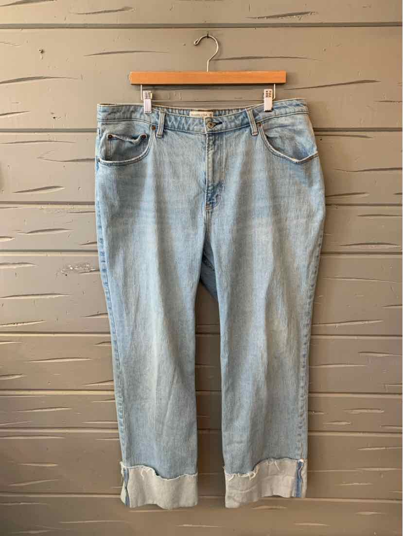 Light blue denim jeans with rolled cuffs, classic five-pocket design, and belt loops.