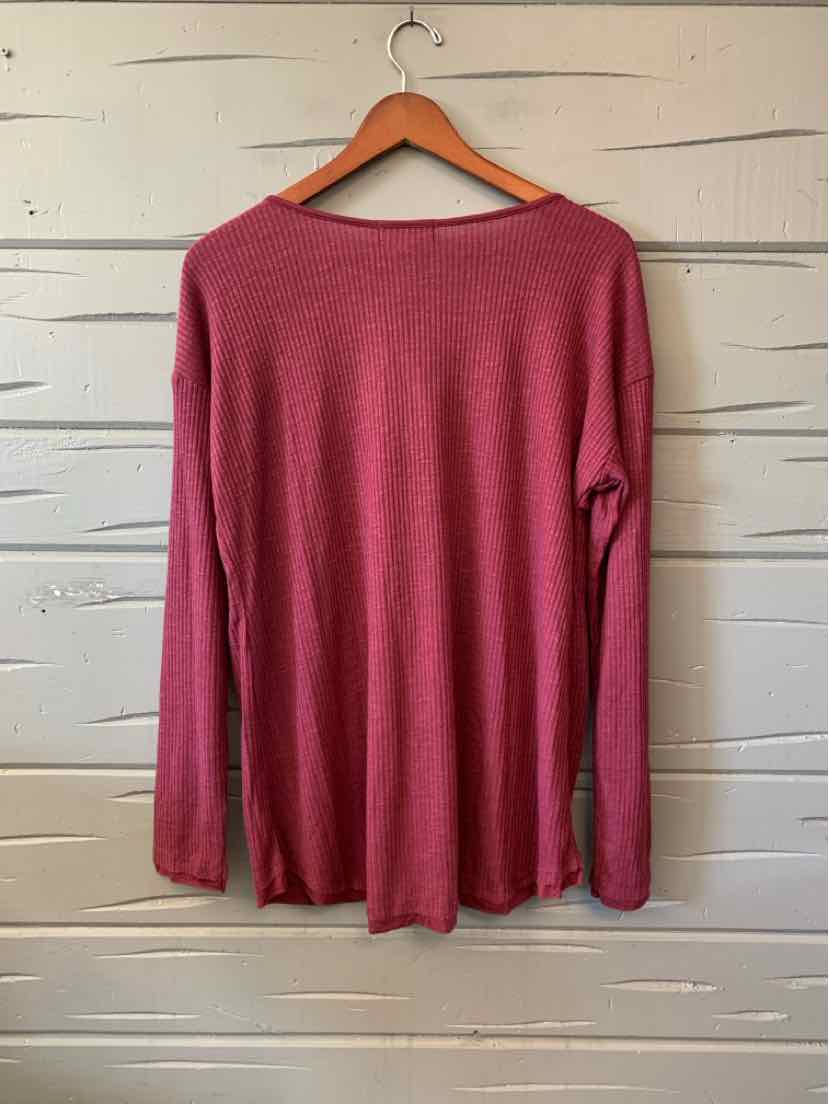 Burgundy long-sleeve women's casual top with relaxed fit on wooden hanger.
