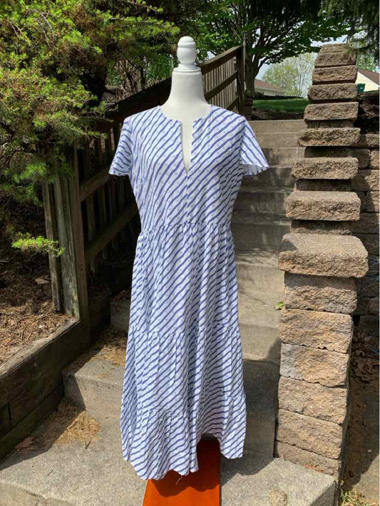 Blue and white striped midi dress with short sleeves and V-neck on mannequin outdoors.